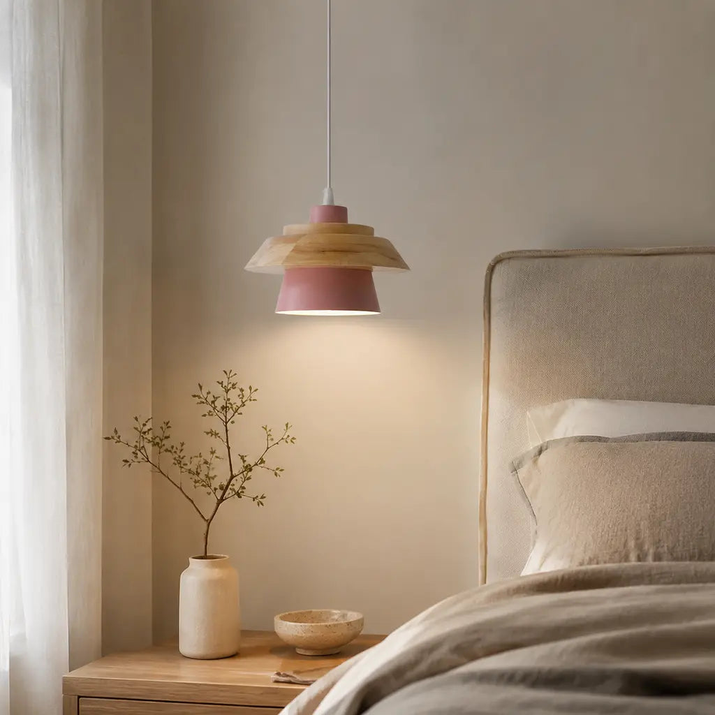 Nordic Iron & Wood Pendant Light in pink beside a modern bed