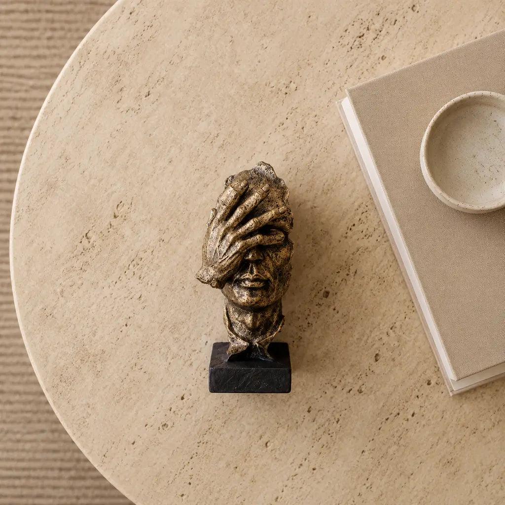 Odin's Faces Thinker sculpture in a top-down display