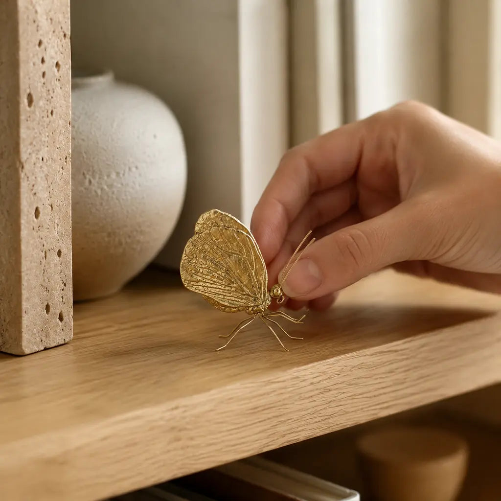 Gold-Finish Zinc Alloy Butterfly Sculpture being placed on a shelf