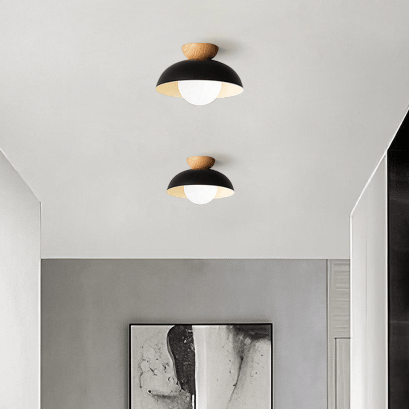 Lattea Global black metal dome flush ceiling light with natural wood cap and frosted glass diffuser.